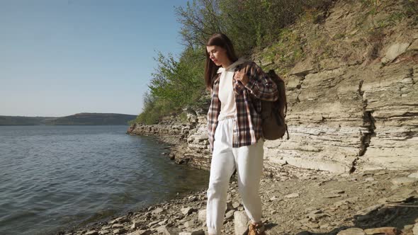 Pleasant Brunette with Backpack Walking Near Dniester River