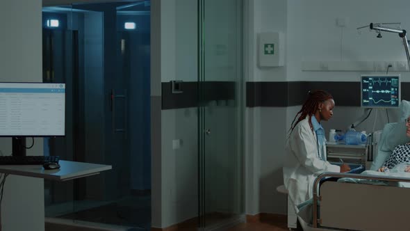 Caucasian Nurse Checking Information Files on Patient