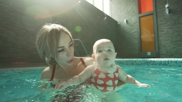 Woman with Her Baby in Swimming Pool