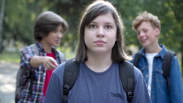 Portrait of Scared Overweight Caucasian Schoolboy Looking at Camera with Fear in Eyes As Blurred