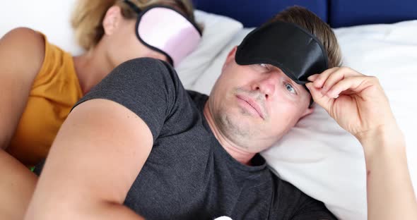 Waking Up Young Man in Sleep Mask Looking Surprised at Woman  Movie