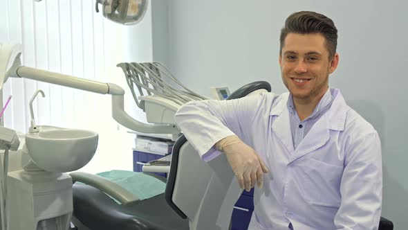 Dentist Poses with Layout of Human Teeth