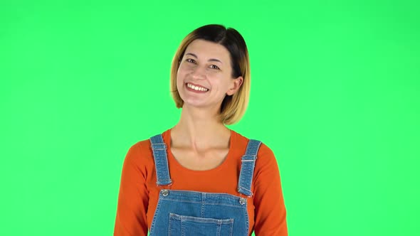 Cute Girl Smiles and Showing Heart with Fingers Then Blowing Kiss. Green Screen