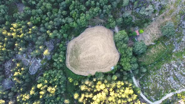 Aerial view of field surrounded by trees in Peneda Geres National Park, Portugal, Europe, circling