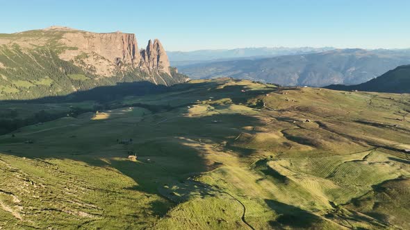 Dolomites mountains peaks with a hiking path on a summer sunrise