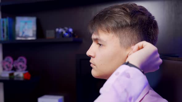 A Young Man Puts on a Digital Hearing Aid. Fourth Degree Hearing Loss. Bilateral Sensorineural