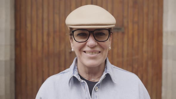 Portrait of a Middle Aged Lady Looking Smiling on Camera Outdoors