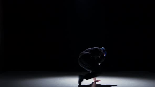 Boy in Blue Hat Dancing Breakdance, on Black, Shadow