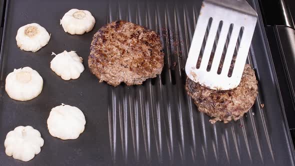 Flipping Beef Burger Patties on Grill