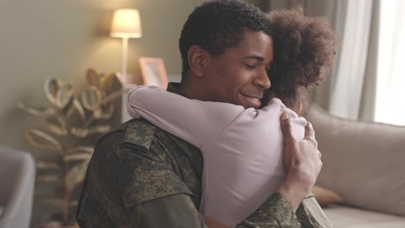 Soldier Embracing Little Daughter after Long Separation alt