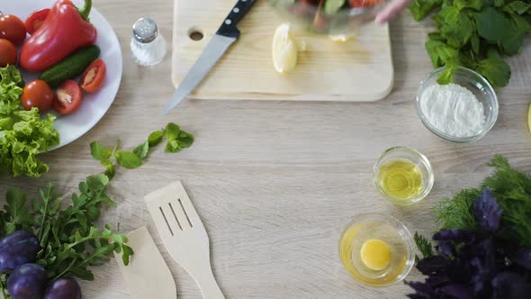 Top View of Female Hands Putting Glass Bowl with Tasty Fresh Salad on The Table