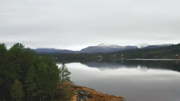 Aerial View Of Calm Lake With Mountain Views On A Cloudy Day In Norway.