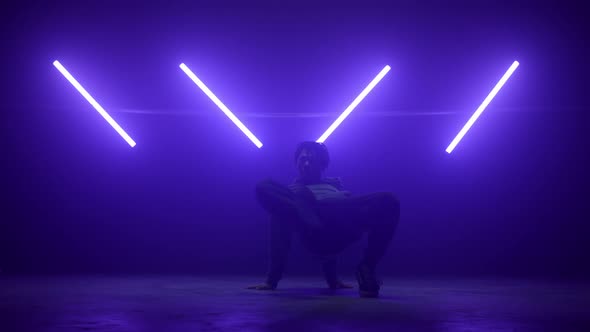 Stylish Dancer Breakdancing Wearing Street Wear at Ultraviolet