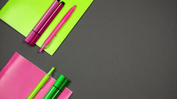 Two Notebooks of Pink and Green Color, Pens and Felt-Tip Pens. Stop Motion 