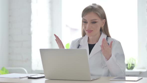 Lady Doctor Talking on Video Call on Laptop in Clinic