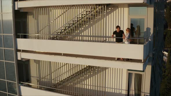 A Young Couple on the Balcony of a Posh Hotel