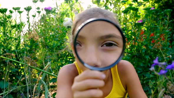 The Child Examines the Plants with a Magnifying Glass