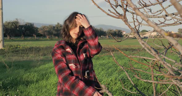 Girl smiles at the sun in green field