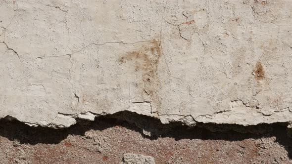 Slow tilt brick wall and remains of white cement plaster  4K 2160p 30fps UltraHD footage - Close-up 