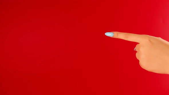 Woman's Hand Points Index Finger at Space for Text on Red Background