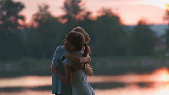 Happy Siblings Hugging Lovingly in Summer Park