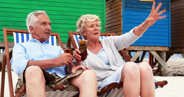 Senior couple interacting with each other at the beach