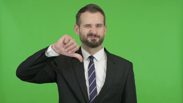 Young Businessman Showing Thumbs Down Against Chroma Key