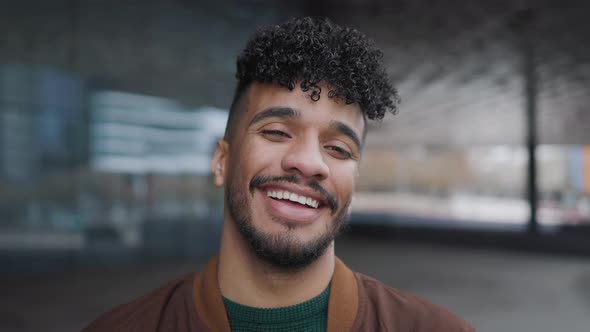 Happy young Latin man smiling in front of camera