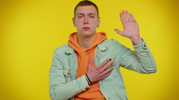 Sincere Responsible Teen Man Raising Hand to Take Oath Promising to Be Honest and to Tell Truth