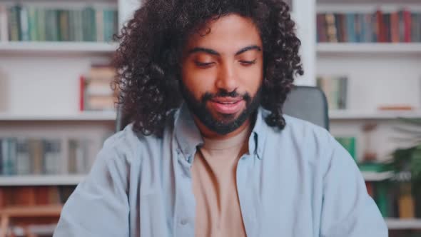 Young Happy Arabian Man Freelancer Opens Laptop and Typing Sits in Home Office