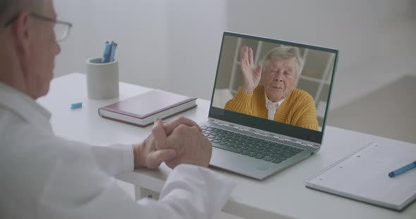 Elderly Man Is Calling To Family Doctor By Video Call, Talking and Consulting with Him, Doctor Is