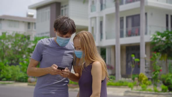 Quarantine Is Over Concept. Woman and Man Take Off Medical Masks on a Street. We Are Safe