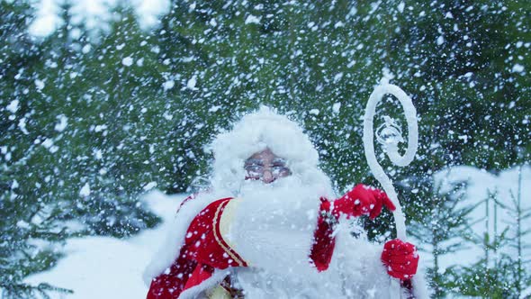 Cheerful Santa Claus during snowfall