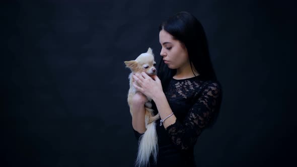 Elegant Girl with Puppy on Hands