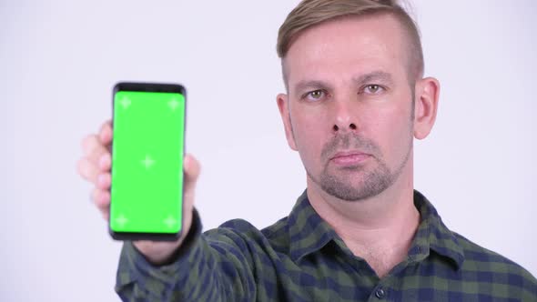 Portrait of Happy Blonde Hipster Man Showing Phone