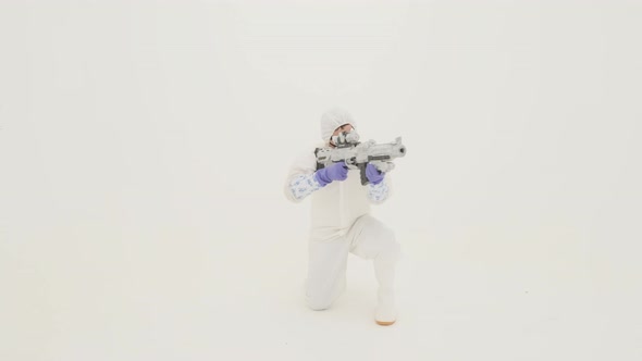 Man in white chemical protection suite aims with fake assault rifle