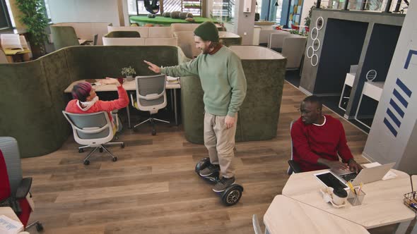 Businessman Riding Hoverboard and High-Fiving Colleagues