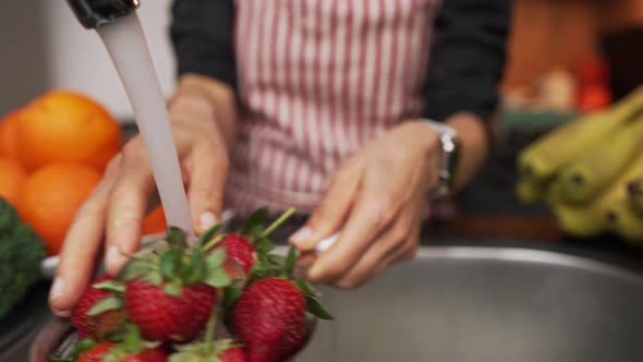 Woman Hands Washing Strawberries in the Kitchen