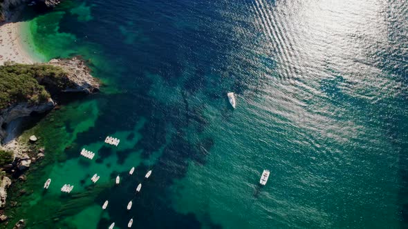 Aerial Drone View to Clear Blue Sea Water with Moored Boats and Yachts