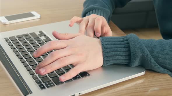 Male Hands Typing on Laptop Keyboard