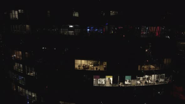 Aerial View From Drone on Glass Facade of Modern Skyscraper with Offices at Night