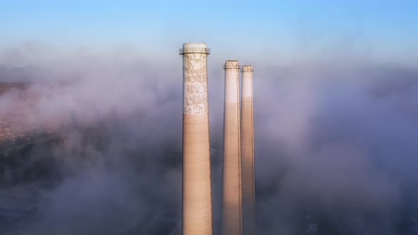 Epic Aerial of Smoke Stacks of Power Plant with Purple Clouds on Background