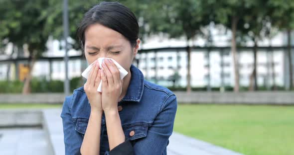 Woman Sneeze at Outdoor