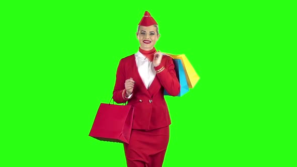 Girl i Is Coming with Shopping Bags. Green Screen. Slow Motion