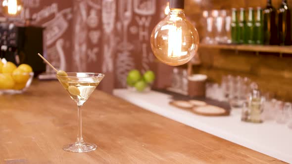 A Glass of Martini on a Bar Counter in an Empty Restaurant Interior