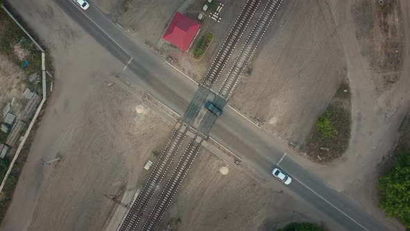Cars Move the Railway Crossing Aerial Drone Shot