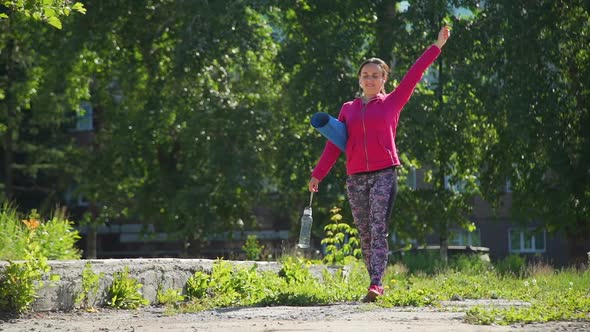 Fit Woman Walking After Work Out in a Summer Park