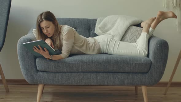 Girl Comes to Sofa Lying Down Start Working with Family Budget