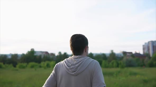 An Adult Man Runs in Headphones in the Park, Sports Are Part of His Life