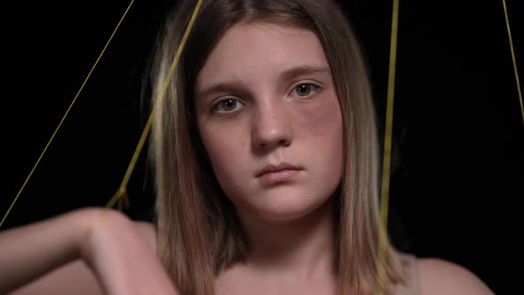 Closeup Indifferent Teenage Girl Looking at Camera As Strings Moving Hands